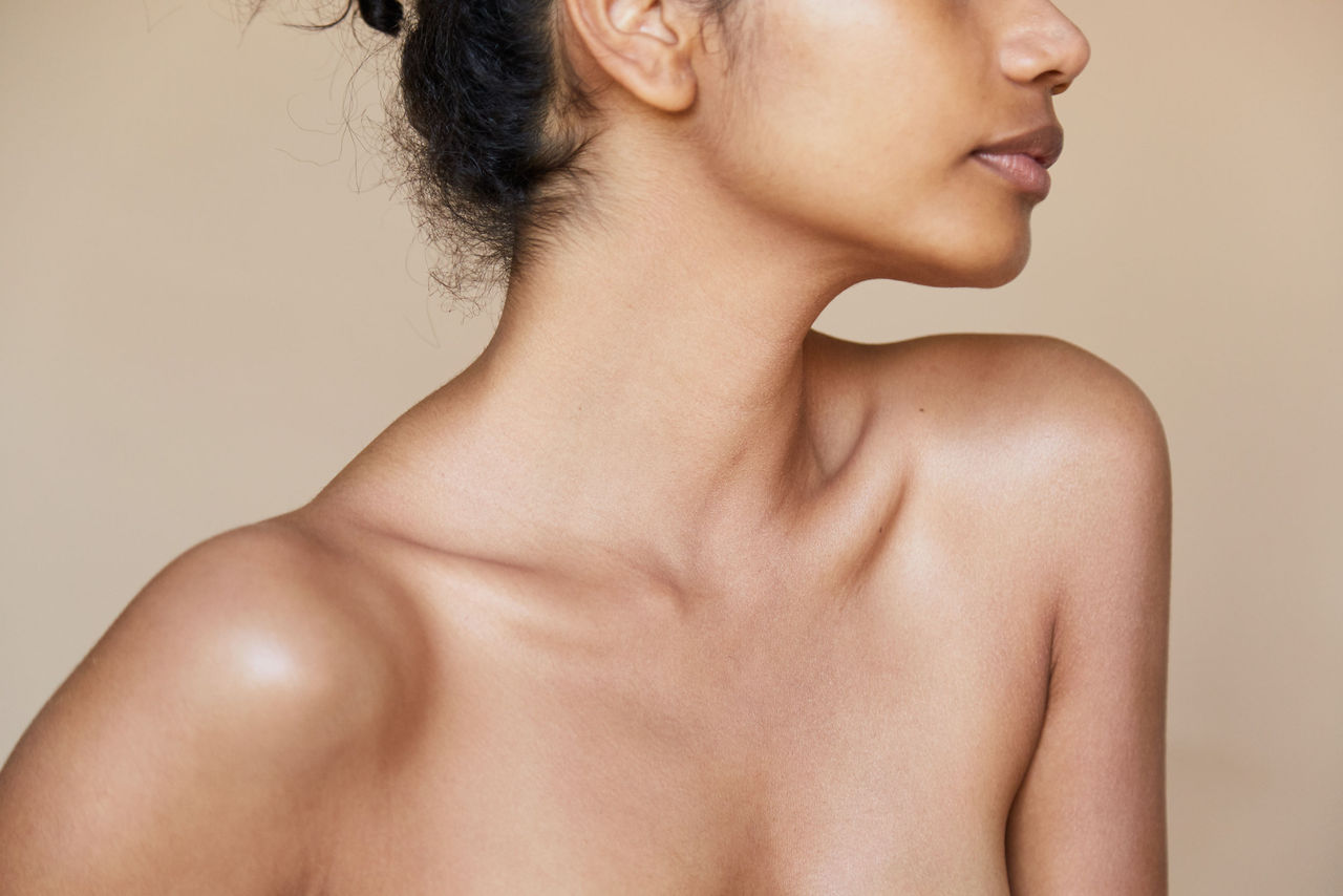 closeup of model's collar bone, lower-third of face